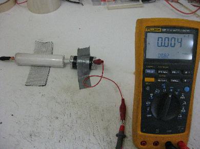 Measuring the capacitance of the same geometry with air.