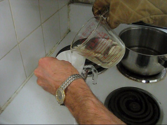 Step 6 in making rochelle salt piezoelectric crystal, filtering the solution by pouring it through a coffee filter.