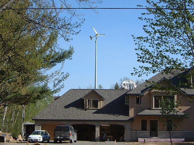 View through the trees of the wind turbine.