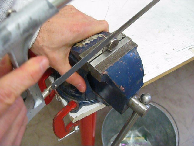 Cutting open the case of a 2N3055 transistor to make a solar cell.