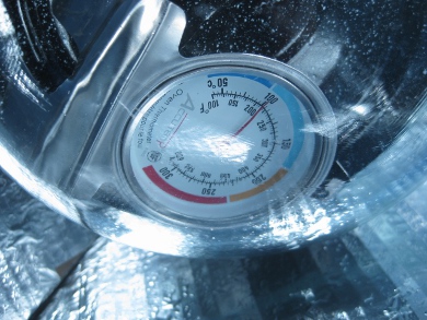 The themometer showing 100C (212F) while solar cooking using
      the Modified CooKit solar cooker.