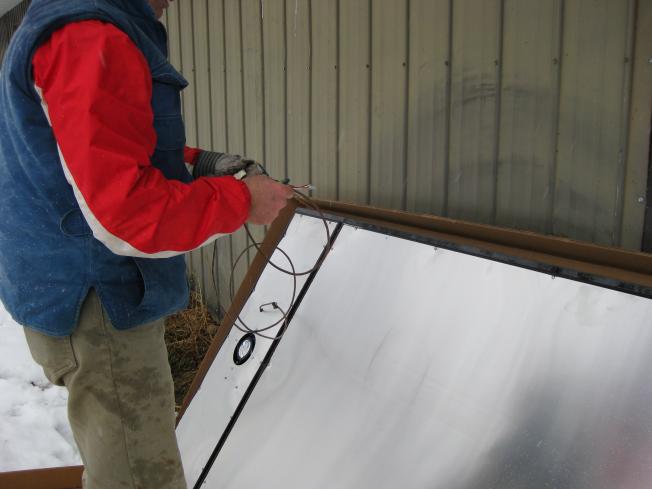 Preparing to push it through the hole to the inside of the barn.