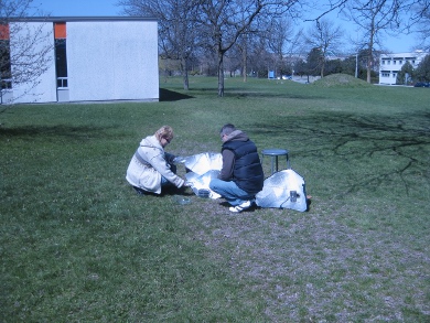 Solar cooking course students checking on the food.