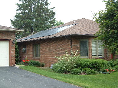 Solar pool heating panels on a roof - view from the ground.