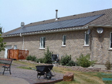 Solar pool heating panels on a roof - view from the ground.