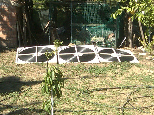 Three flat spiral solar heat collectors.