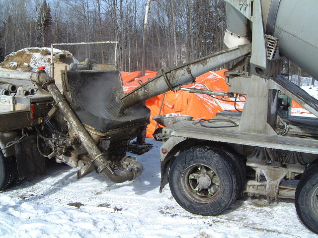 Concrete truck delivering concrete.