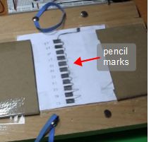 Rectangular graphite pencil marks representing different musical notes.