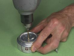 Drilling the hole in the center for filling the alcohol stove.