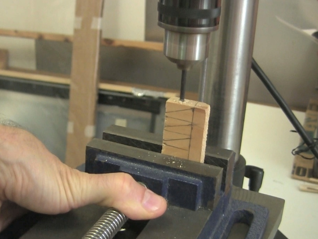 The wedges all drawn in a stack on a piece of wood, and drilling through all the stack at once.