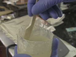 Mixing the resin and hardener in a container.