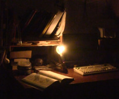 Electric fly swatter powering a CFL as a desk light.