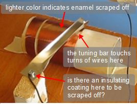 This shows where electrical contact is being made with the crystal radio's tuning coil and tuning bar.