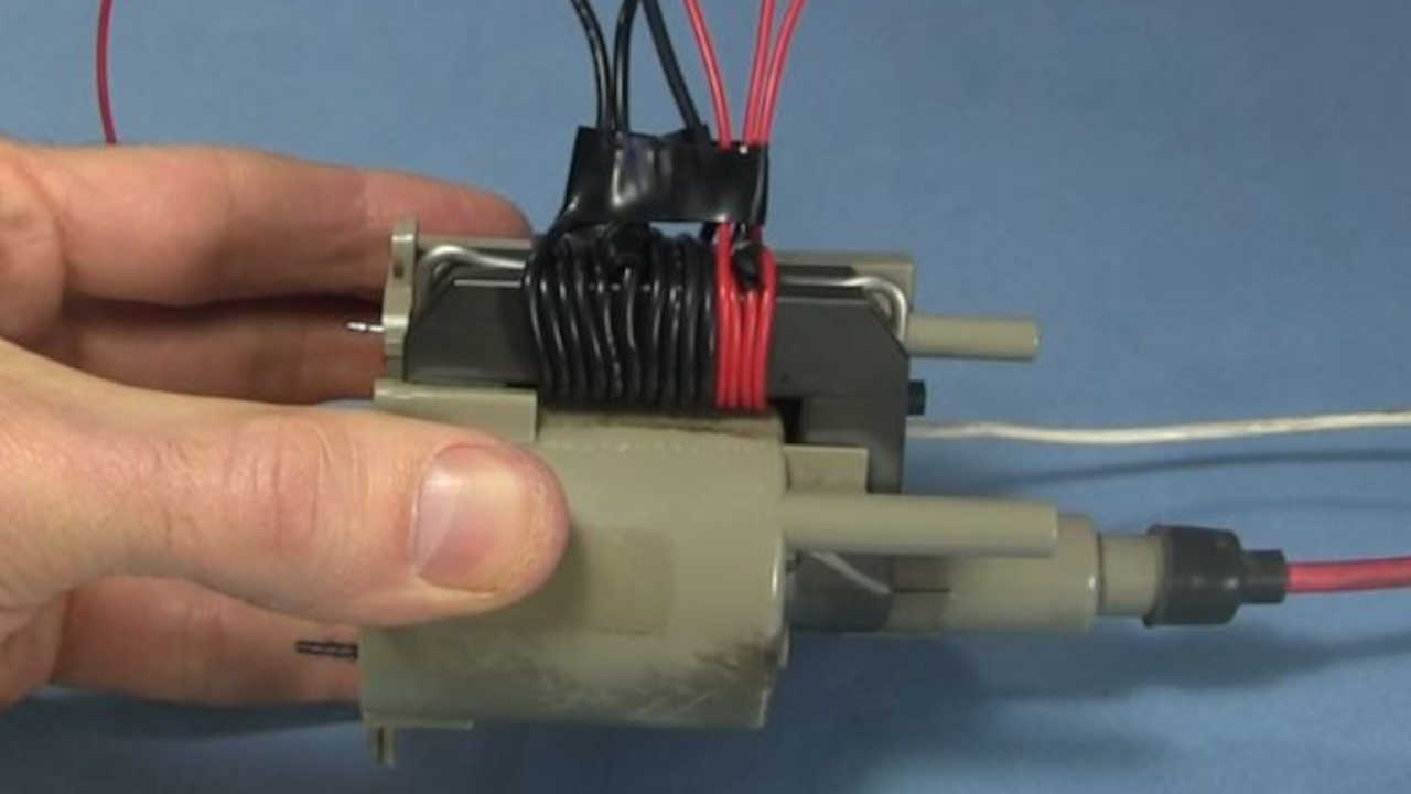 Flyback transformer primary and feedback coils wound on the core.