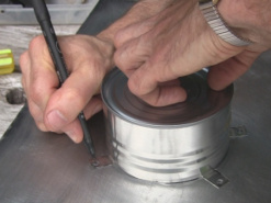 Marking displacer housing holes in the plate for the Stirling engine.