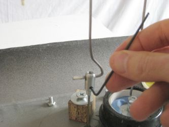 Tightening the set screw using the Allen key for connect the Stirling engine shaft to the rod.