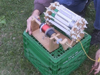 A corona motor with a coil of wire going up into the sky to provide atmospheric electricity.