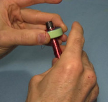 Pulling the coil winding stick out the bottom of the toroid core for the joule thief.