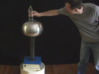 Putting the bottle of water on the Van de Graaff generator's dome.