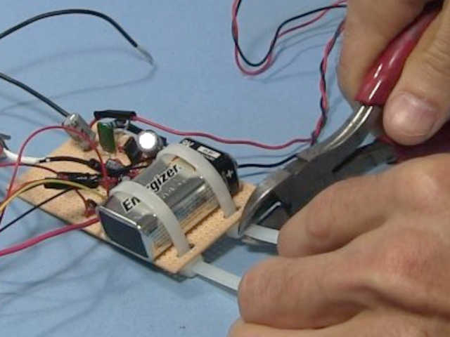 Tie strapping the battery in place on the crystal radio amplifier board.