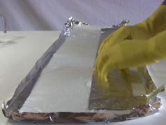 The 1st aluminum foil plate sitting on the electrolyte soaked paper towel.