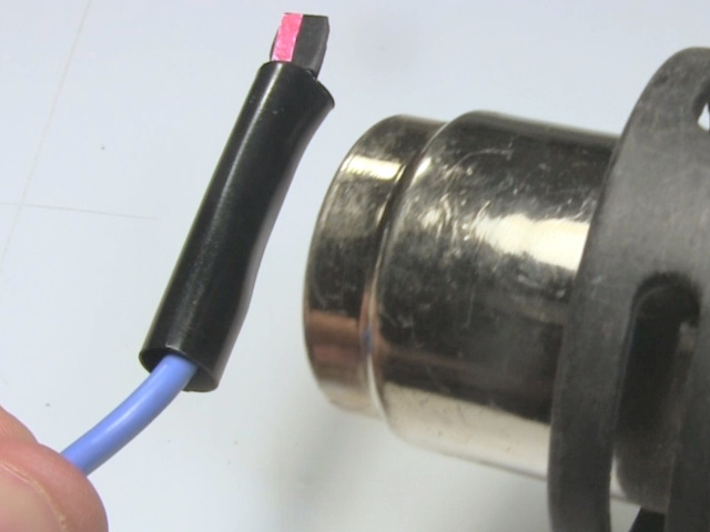 Shrinking the heat shrink using a heat gun.