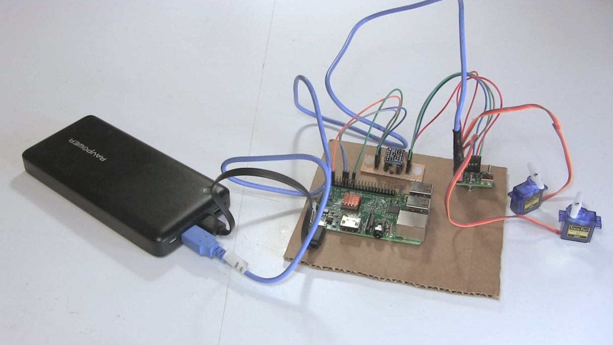 The new USB power cable connected to a phone charger and to a Maestro motor controller board.