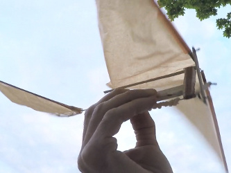 The ornithopter's rubber band and cranking mechanism with the wings down.