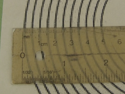 Checking the spacing between the turns on the template using a ruler.