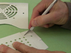 Cutting a plastic leg for the spiral primary coil.